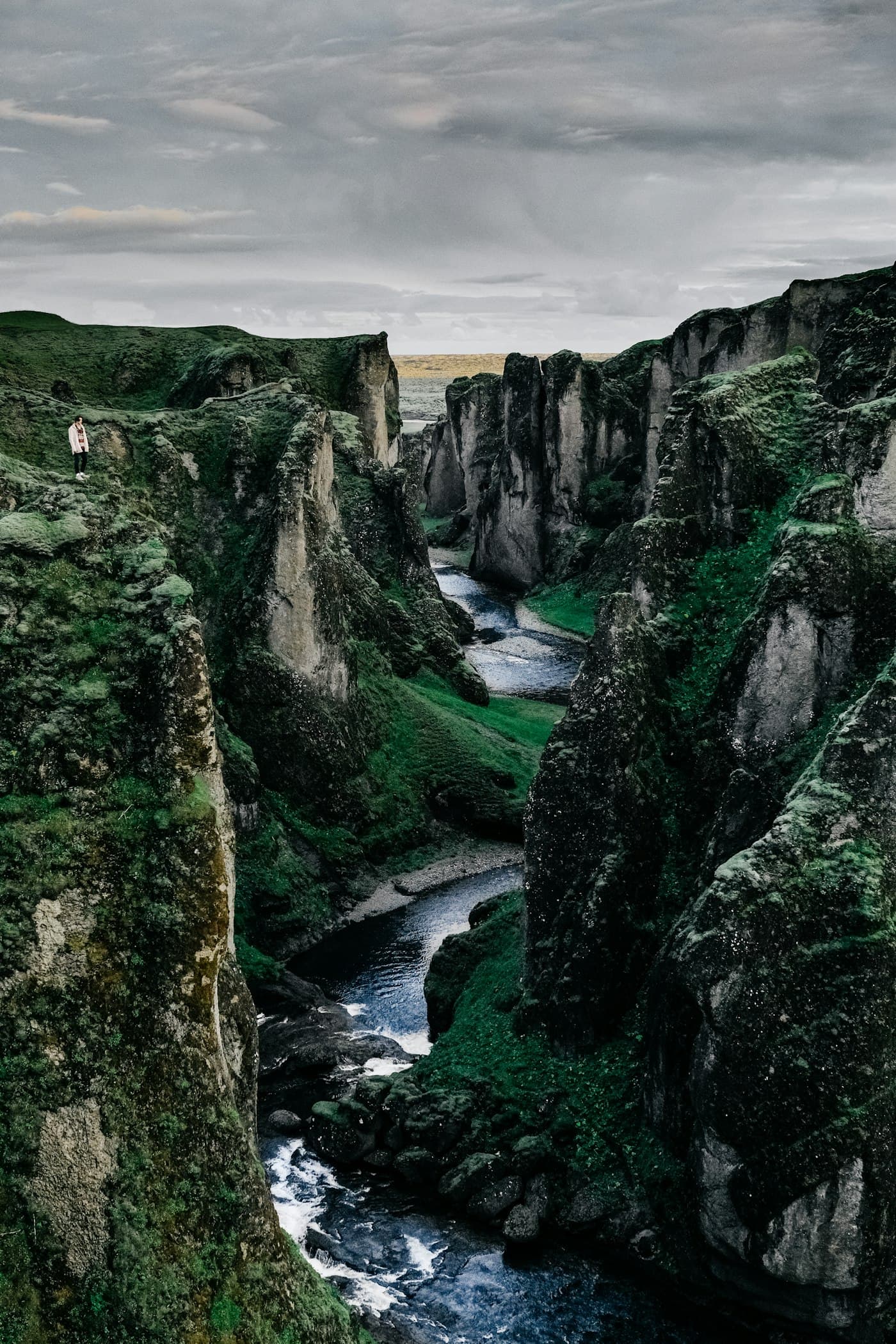 Canyon river flowing through mossy highlands