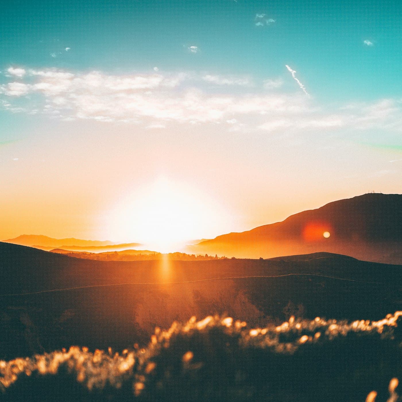 Golden sunrise over mountain grasslands